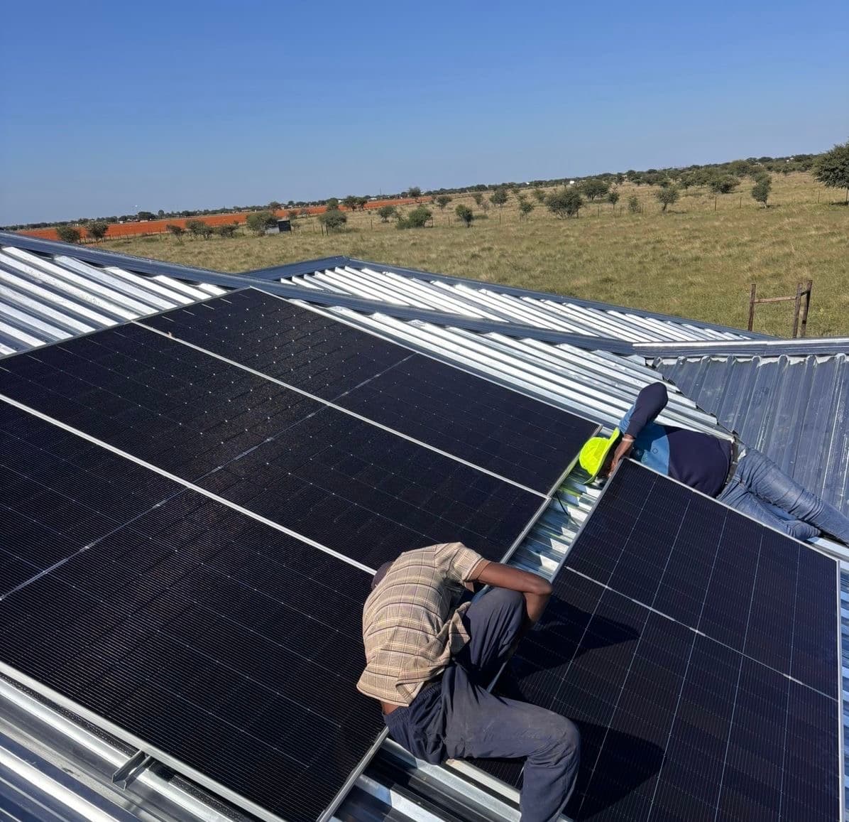 Simply Solar team installing panels on a farm building